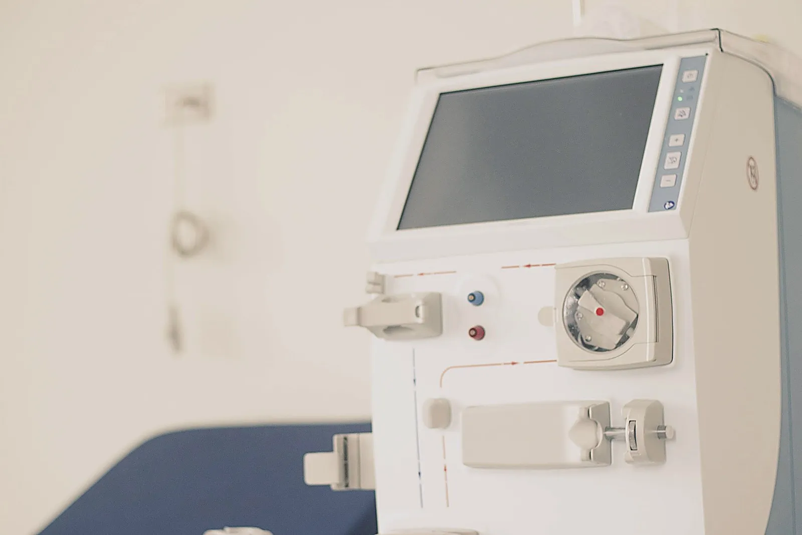 A hemodialysis machine beside a treatment chair