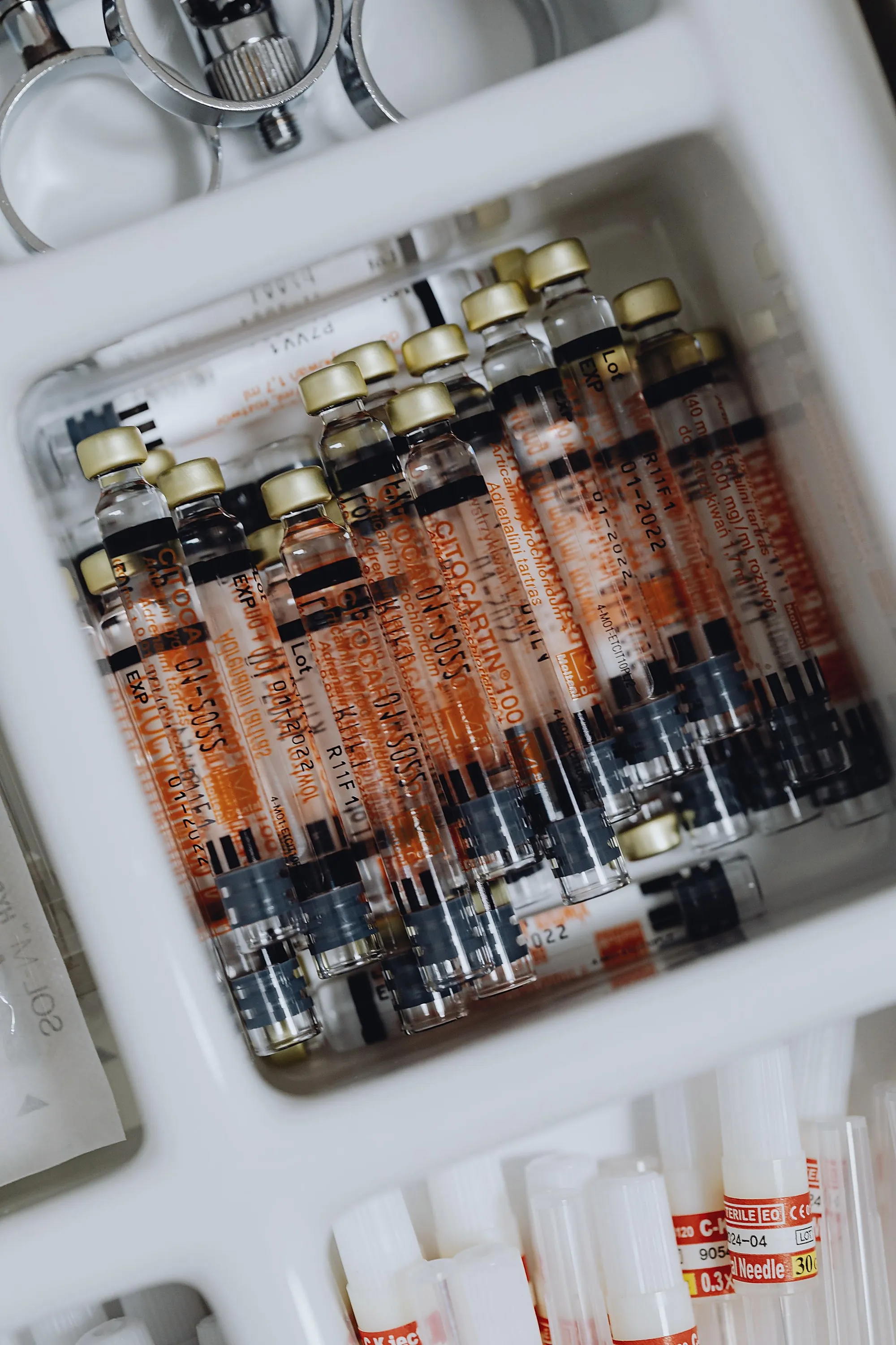Syringes and medication vials laid out in a clinical drawer